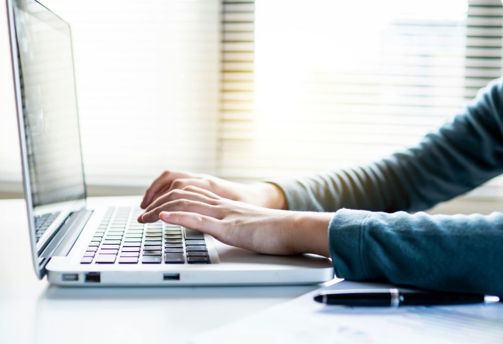 teacher sending email on a laptop